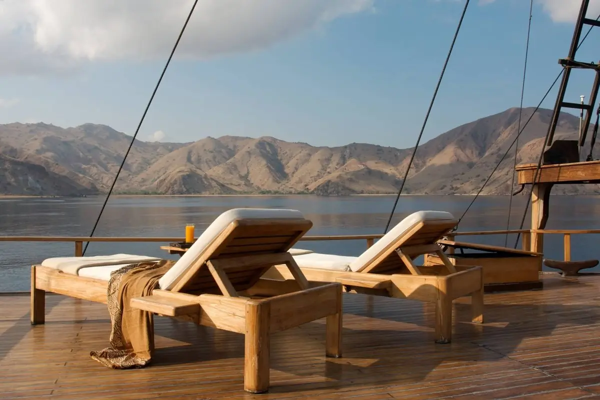Family relaxing on the deck of a private yacht charter in Indonesia