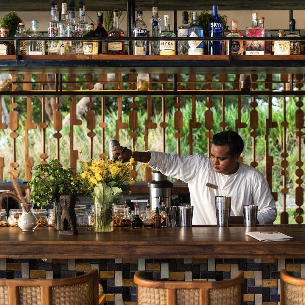 Bartender mixing drinks at the bar at Cap Karoso