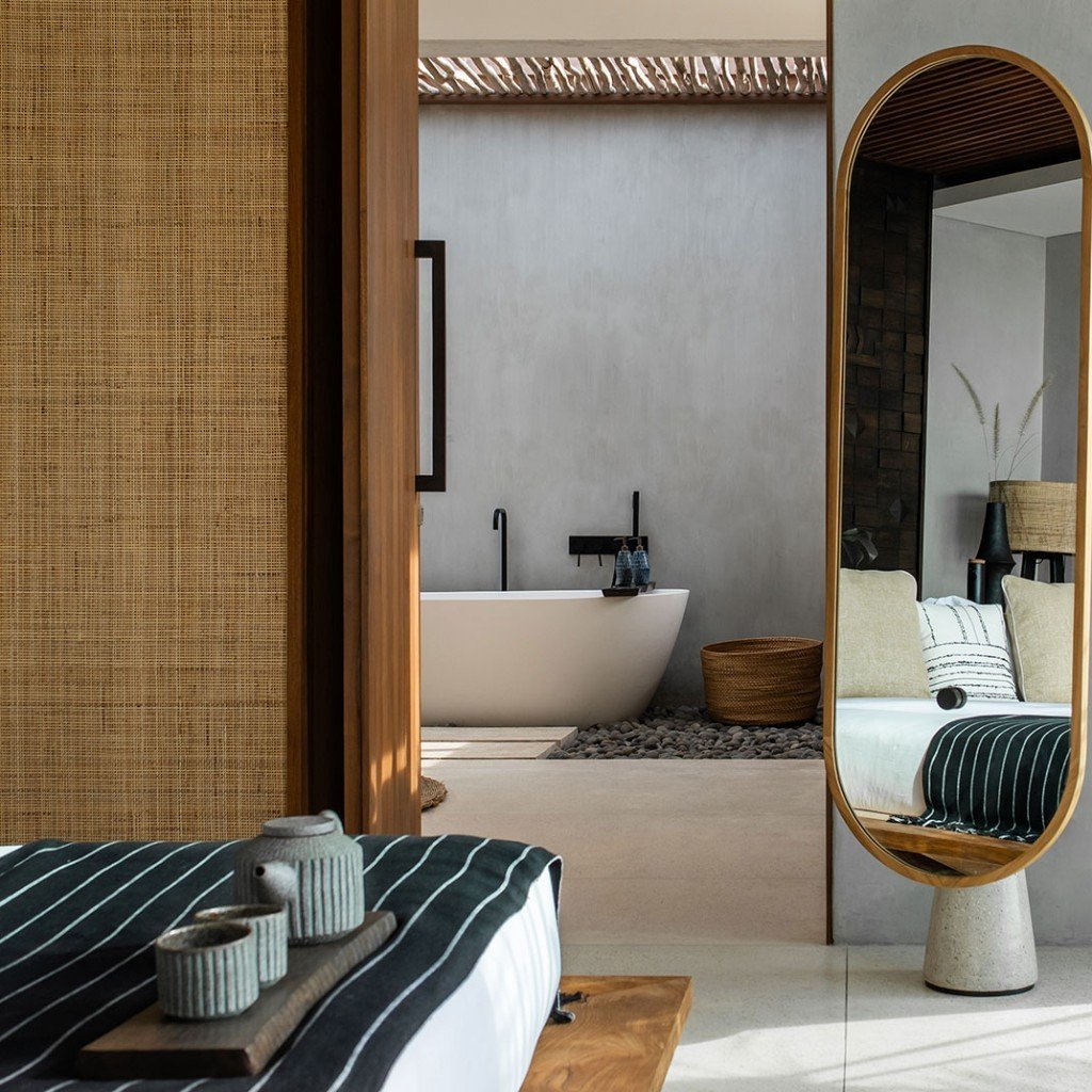 Freestanding bath beside the bedroom in a suite at Cap Karoso