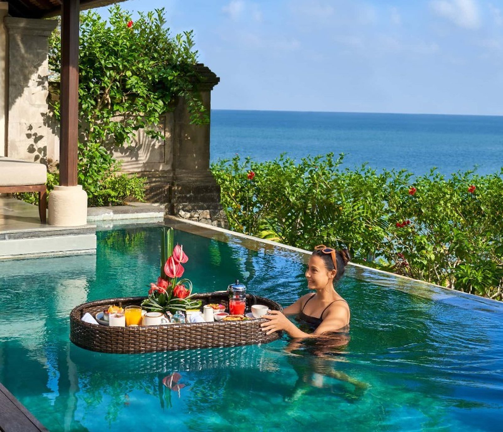 Floating breakfast tray in a private villa pool above the ocean