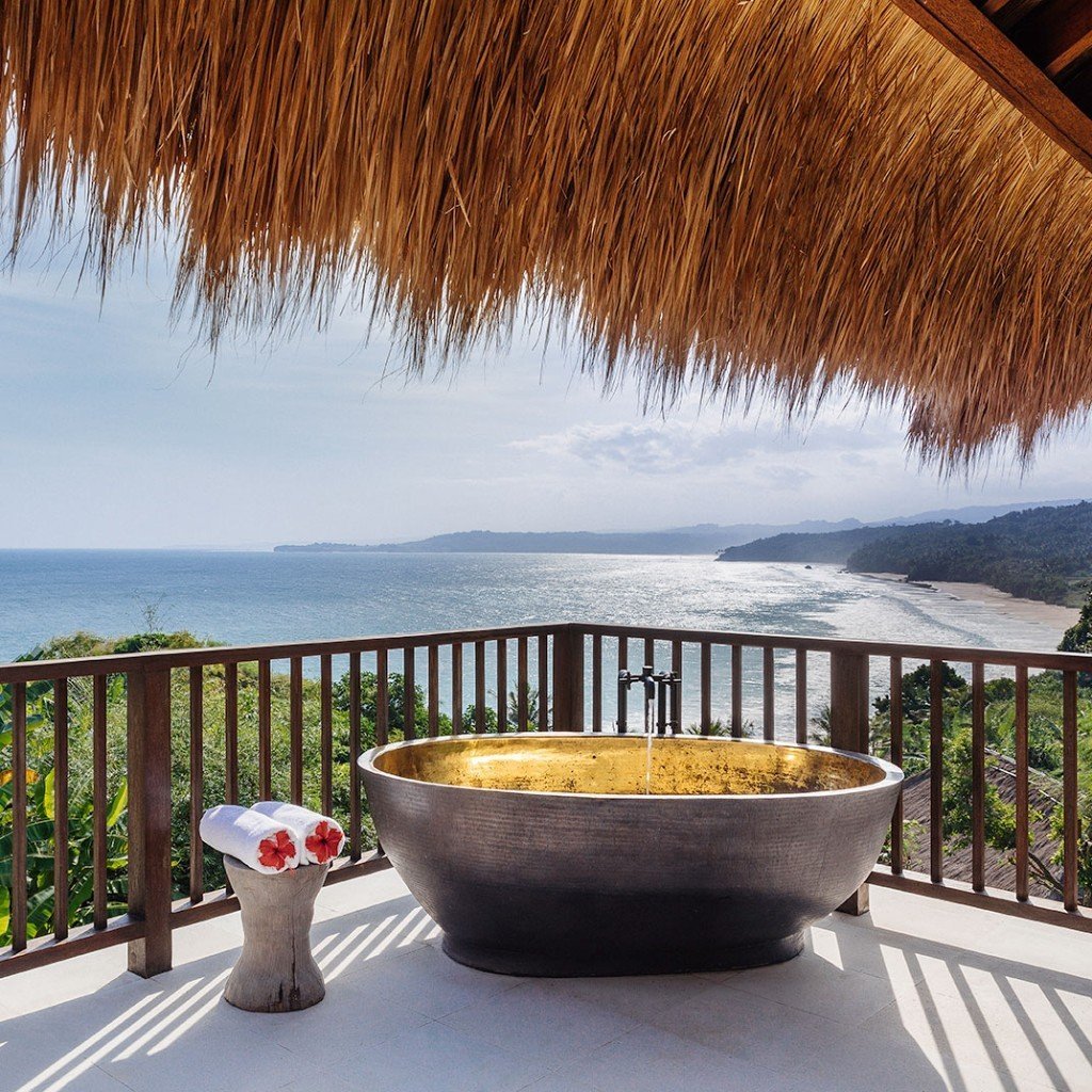 Stone bathtub on a private terrace looking over the coast at Nihi Sumba