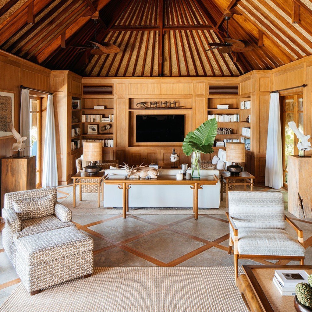 Teak living pavilion under a thatched roof at Nihi Sumba