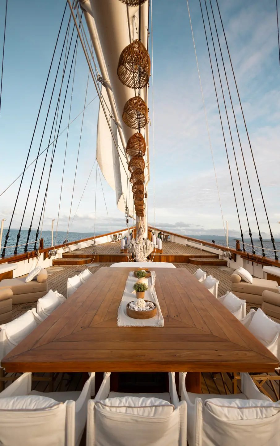 A long dining table set on the deck of Mutiara Laut