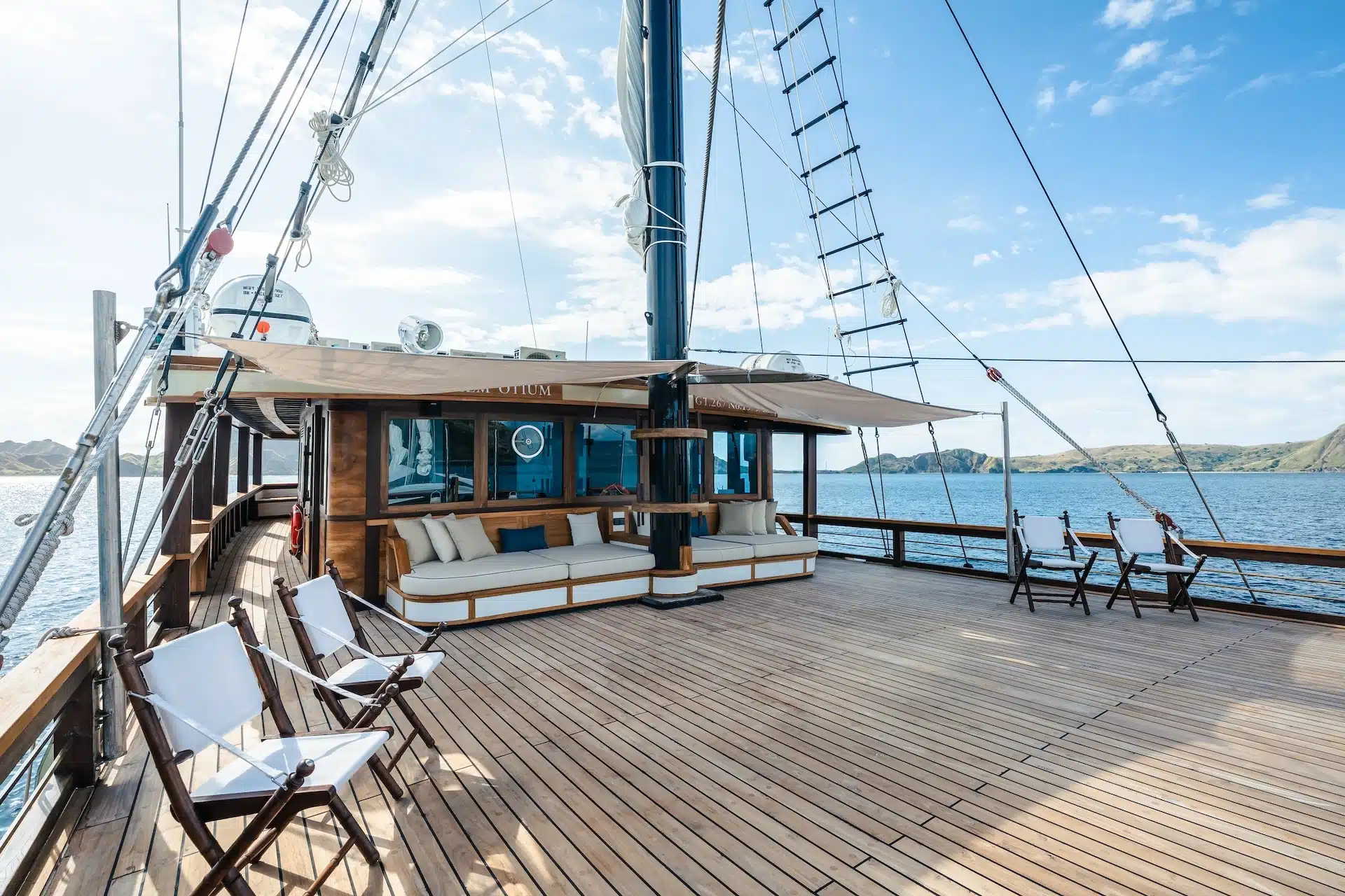 The day club deck on Otium, with the yacht name on the cabin front