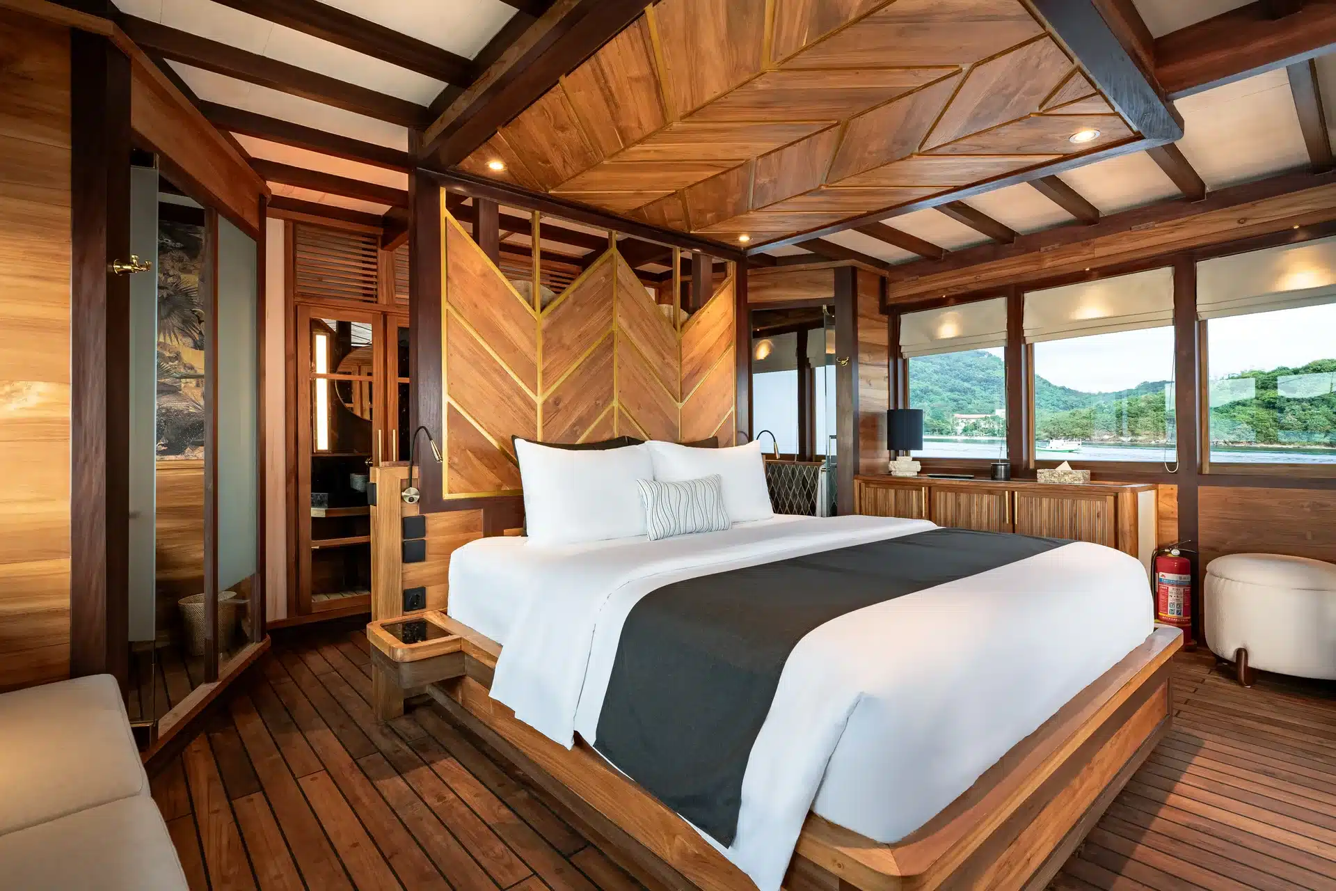 A suite aboard Otium with a chevron wood headboard